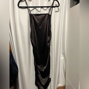 Satin short black dress with rugged detail on the side